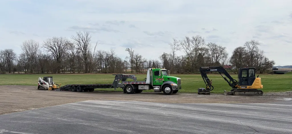 Peterbilt with gooseneck trailer, compact track loader and John Deere 60G excavator